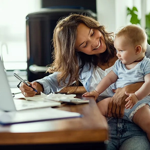 mother with baby filling out paperwork