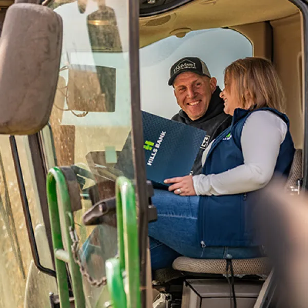 Farmer and banker in farm equipment