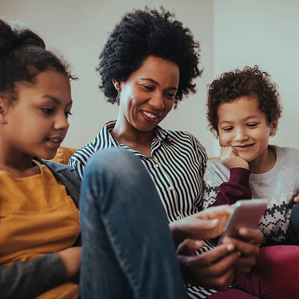 Family seated around phone.