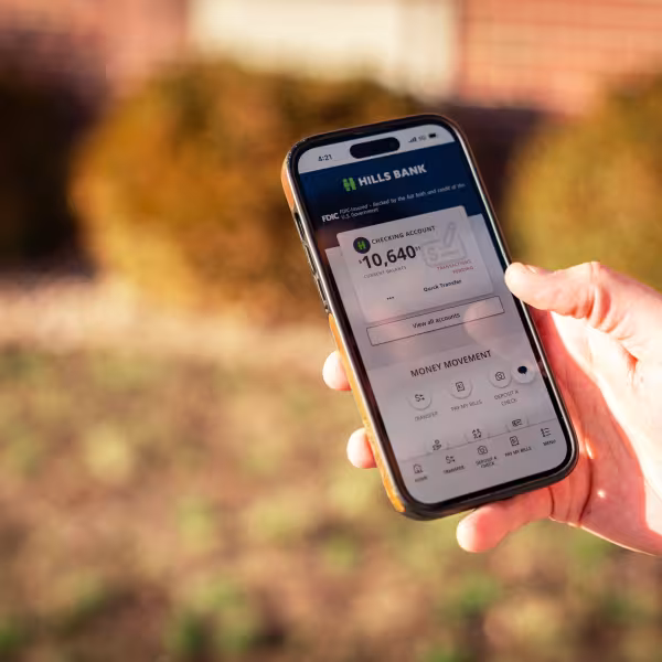 Online banking features being shown up close in the app by an individual.