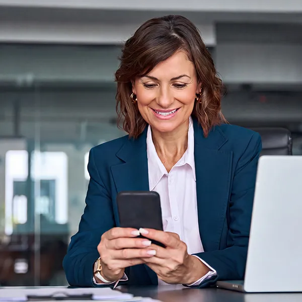business woman smiling at phone