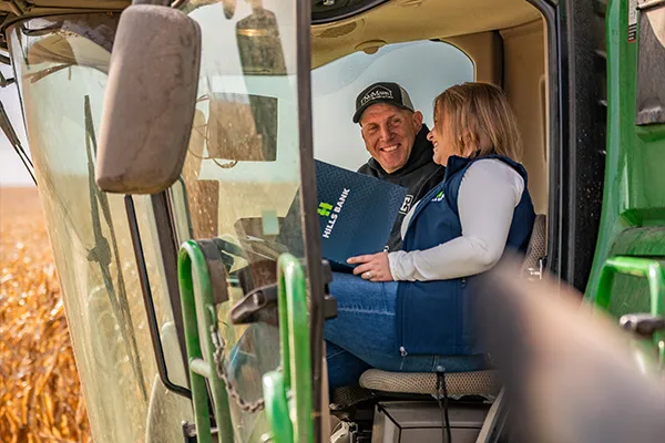 Farmer and banker in farm equipment