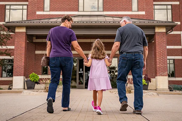 family walking into hills bank