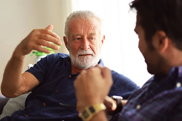 Older man and young adult conversating